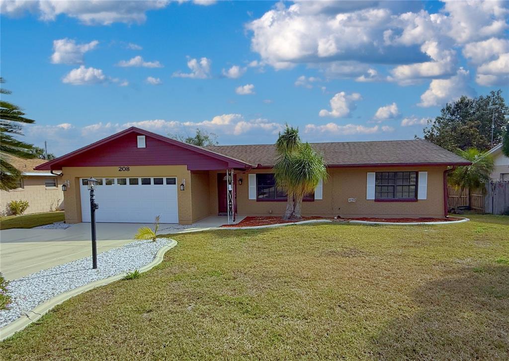 a front view of a house with a yard