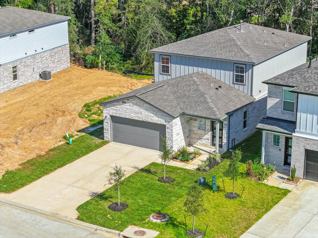 a aerial view of a house with a yard and potted plants