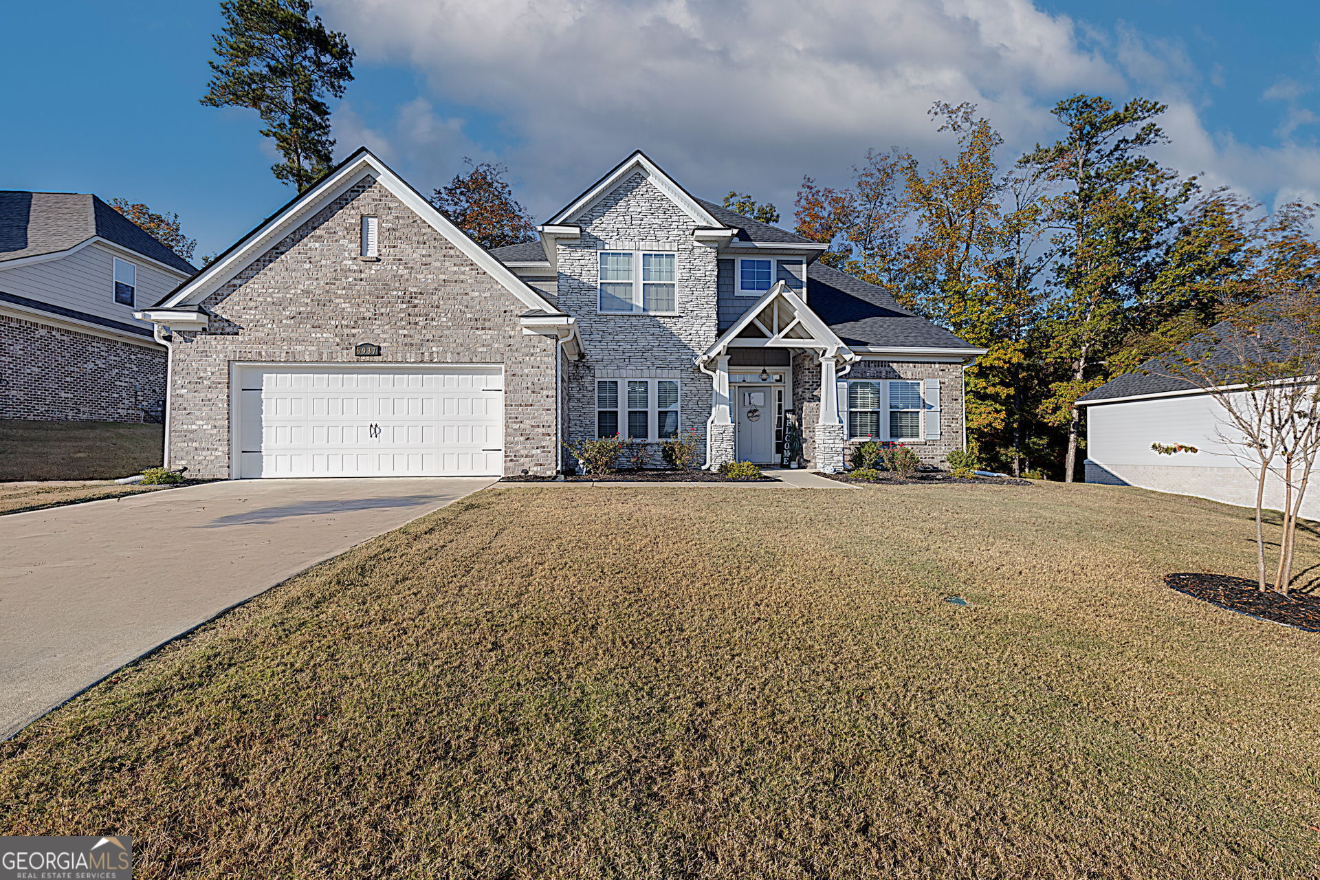 a front view of a house with a yard and garage