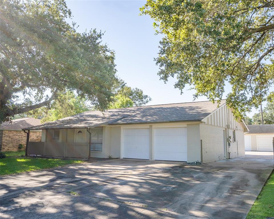 a view of a house with a yard and garage