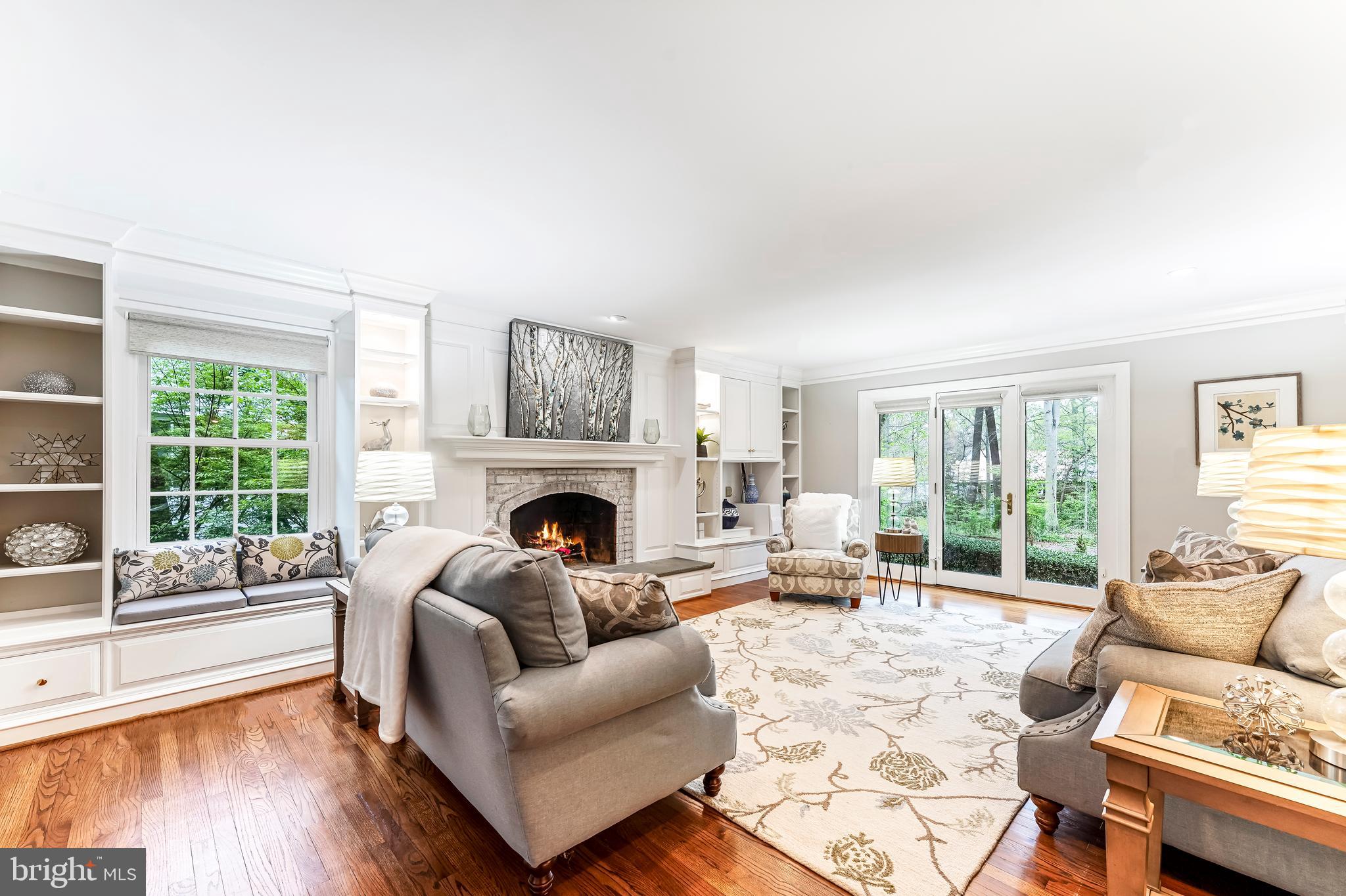 a living room with furniture large window and fireplace