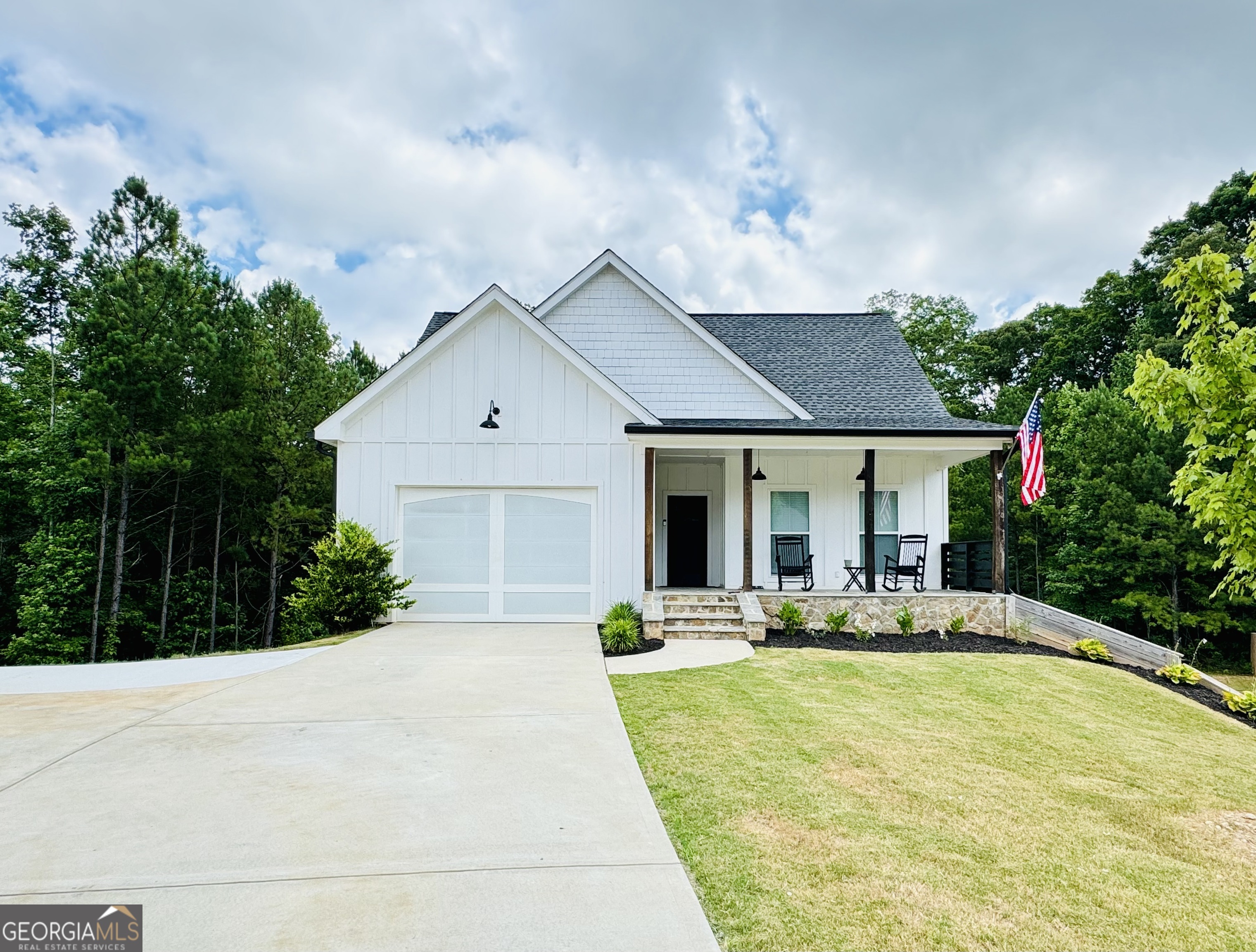 a front view of house with yard outdoor seating and green space