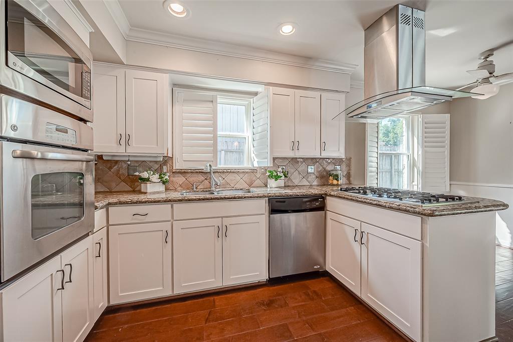 a kitchen with stainless steel appliances granite countertop a stove and a sink