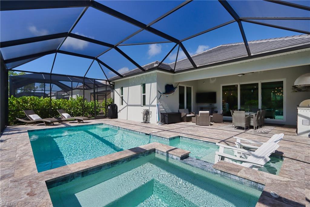 a view of a backyard with swimming pool and sitting area