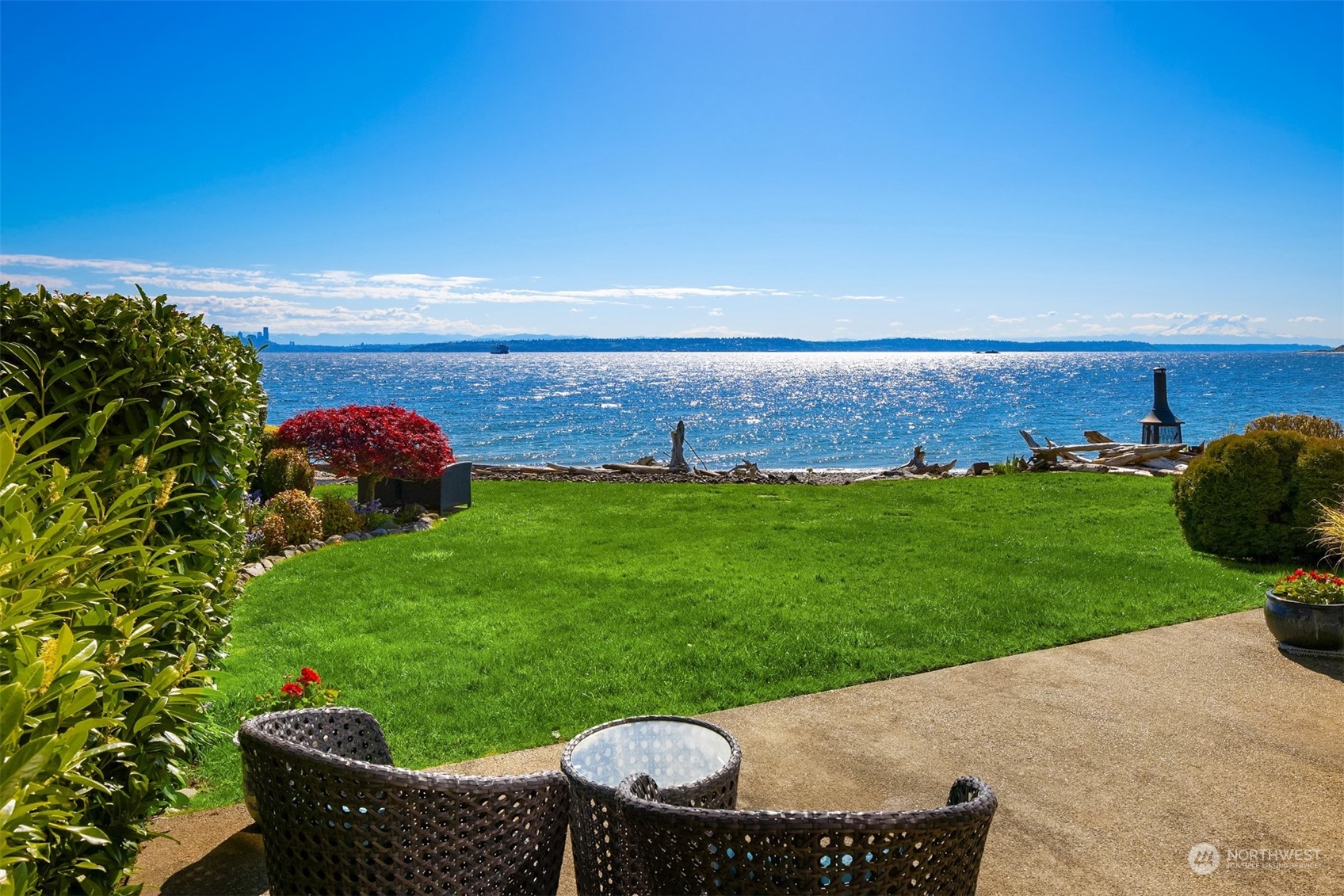 a backyard of a house with table and chairs