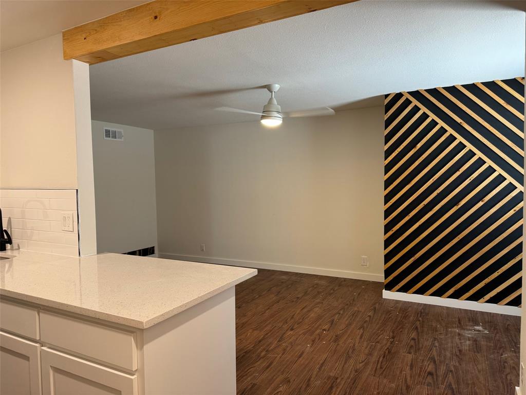 a kitchen view with wooden floor