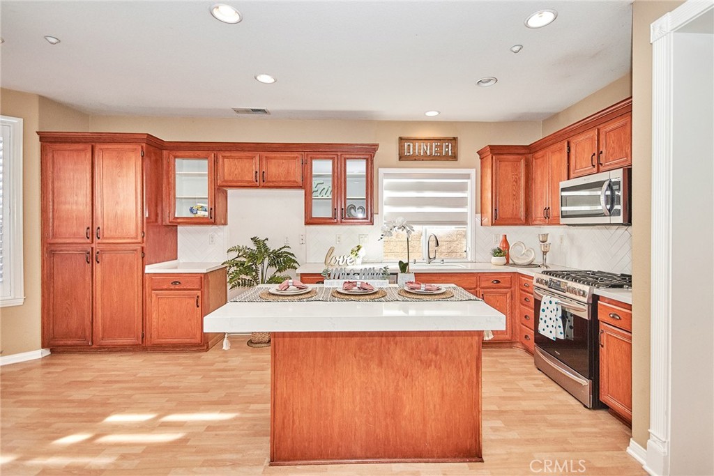 a kitchen with a stove a sink and a refrigerator