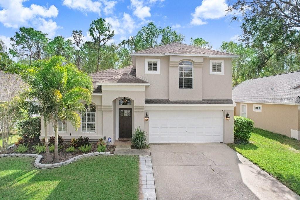 a front view of a house with a yard garage and outdoor seating