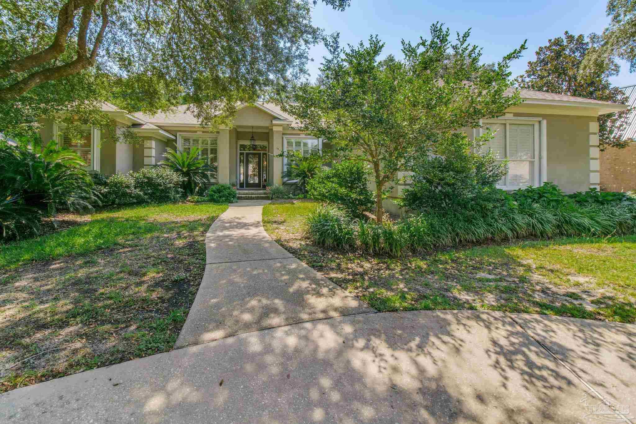 a front view of a house with garden