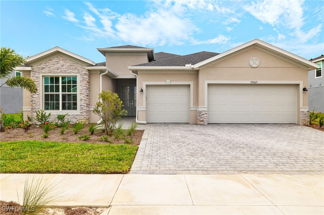 a front view of a house with a yard and garage