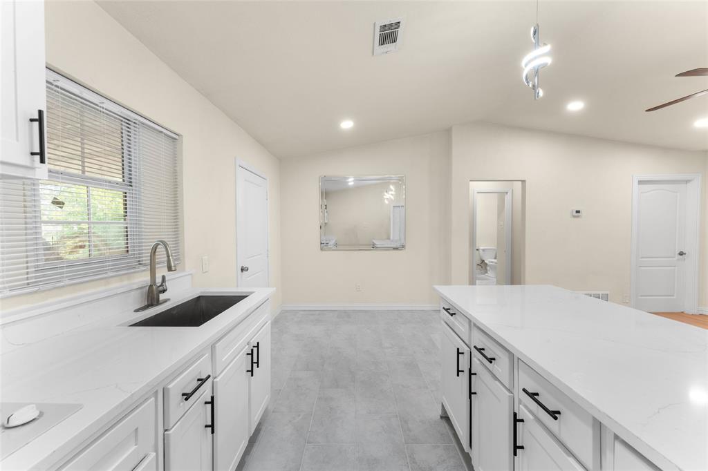 a spacious bathroom with a sink and a mirror