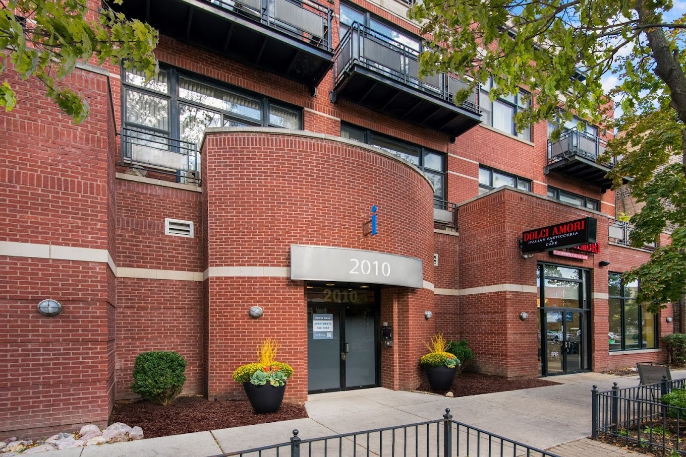 a front view of a building with potted plants