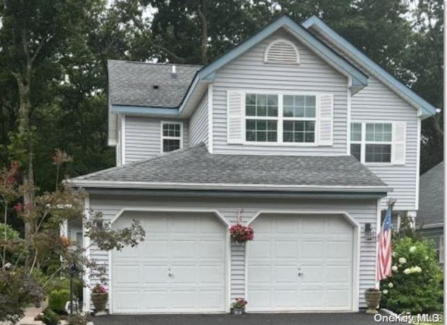 a front view of a house with garage