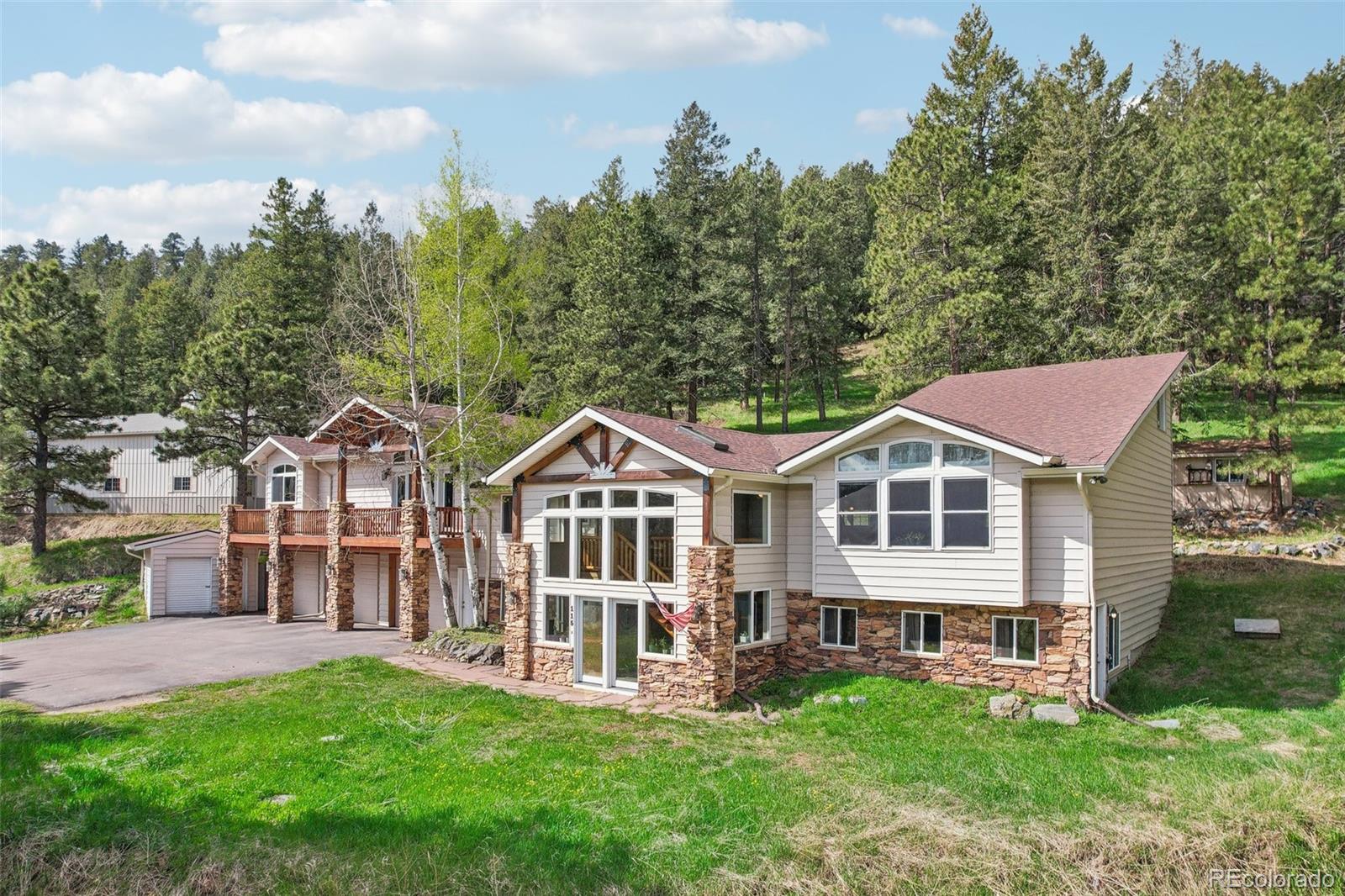 a view of a house with a yard and deck