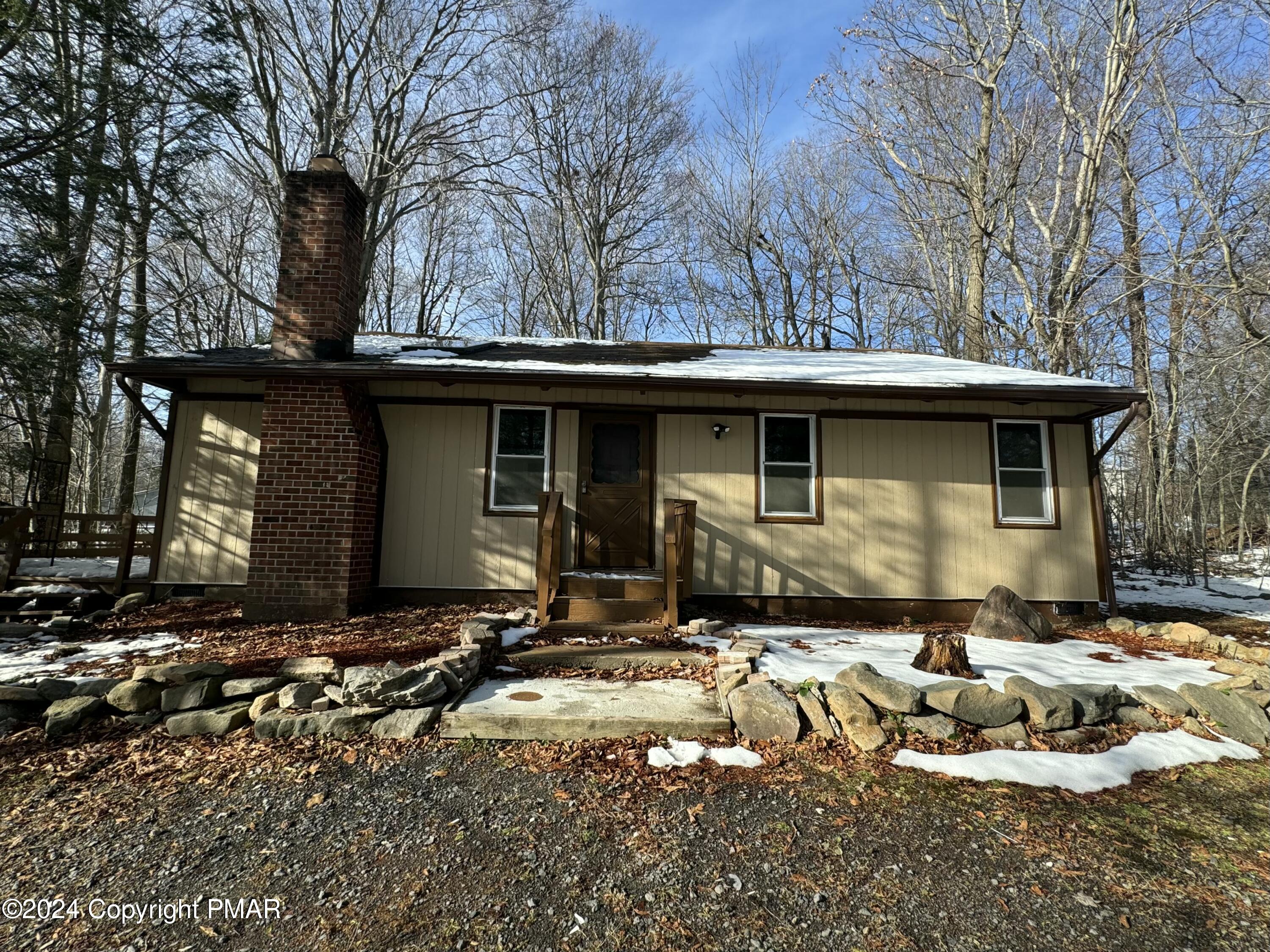 a front view of a house with yard fire pit and outdoor seating