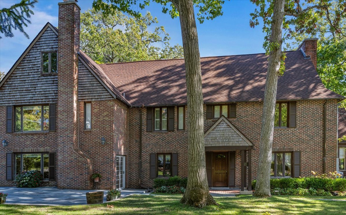 a view of a house with a tree and a yard