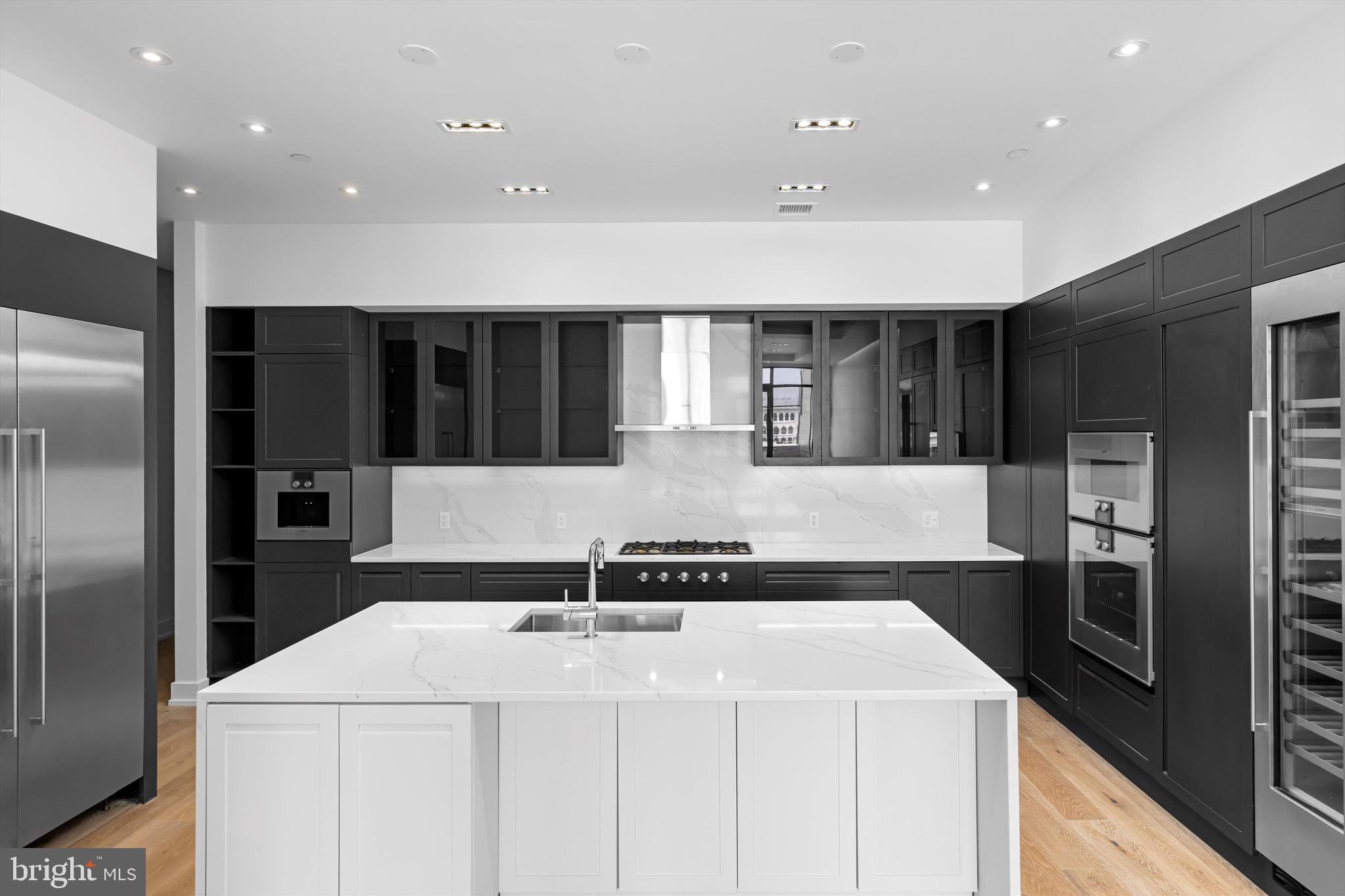 a kitchen with a sink and refrigerator