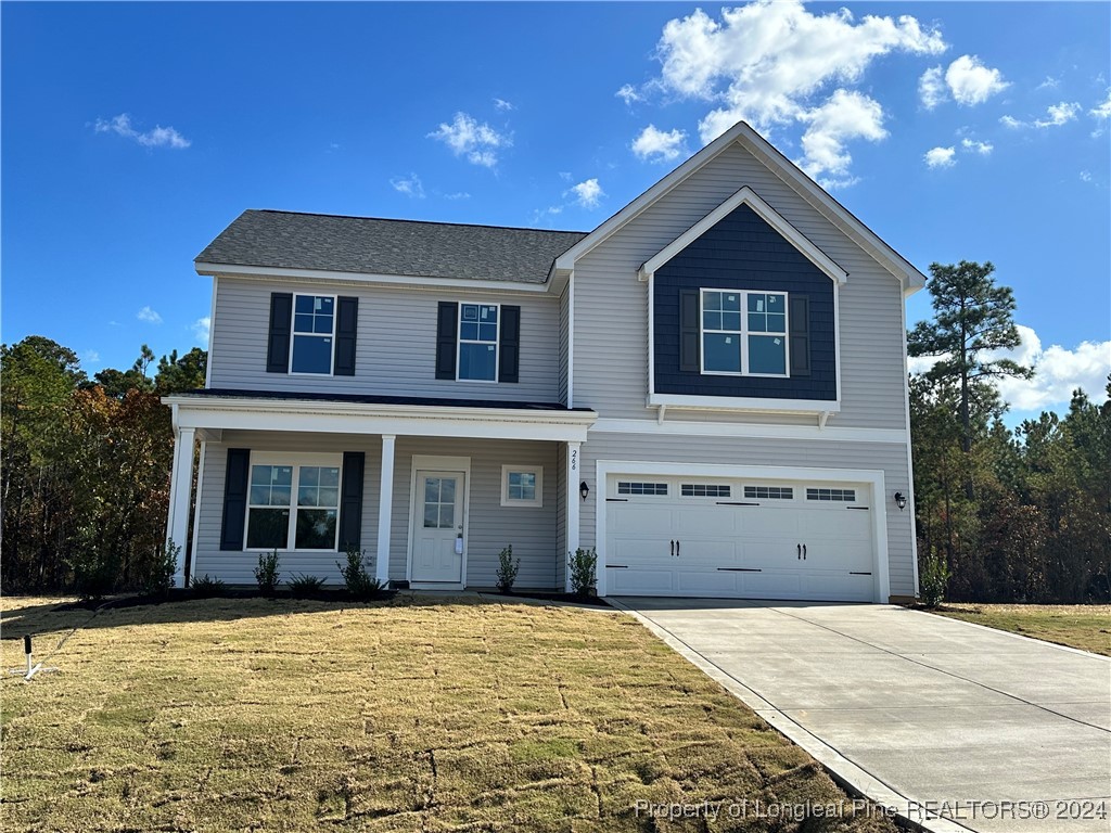 a front view of a house with a yard and garage