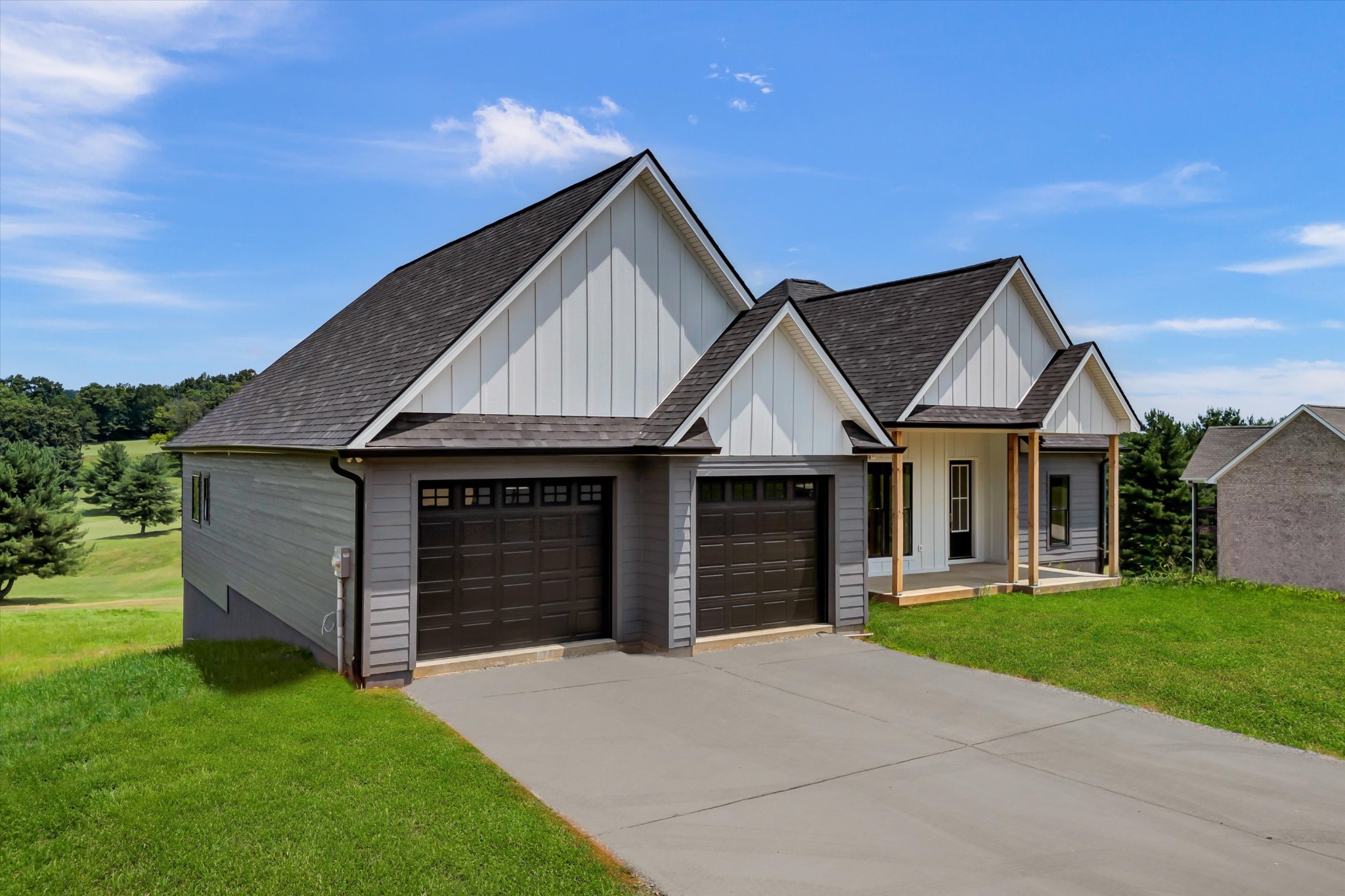 a front view of a house with a yard and garage