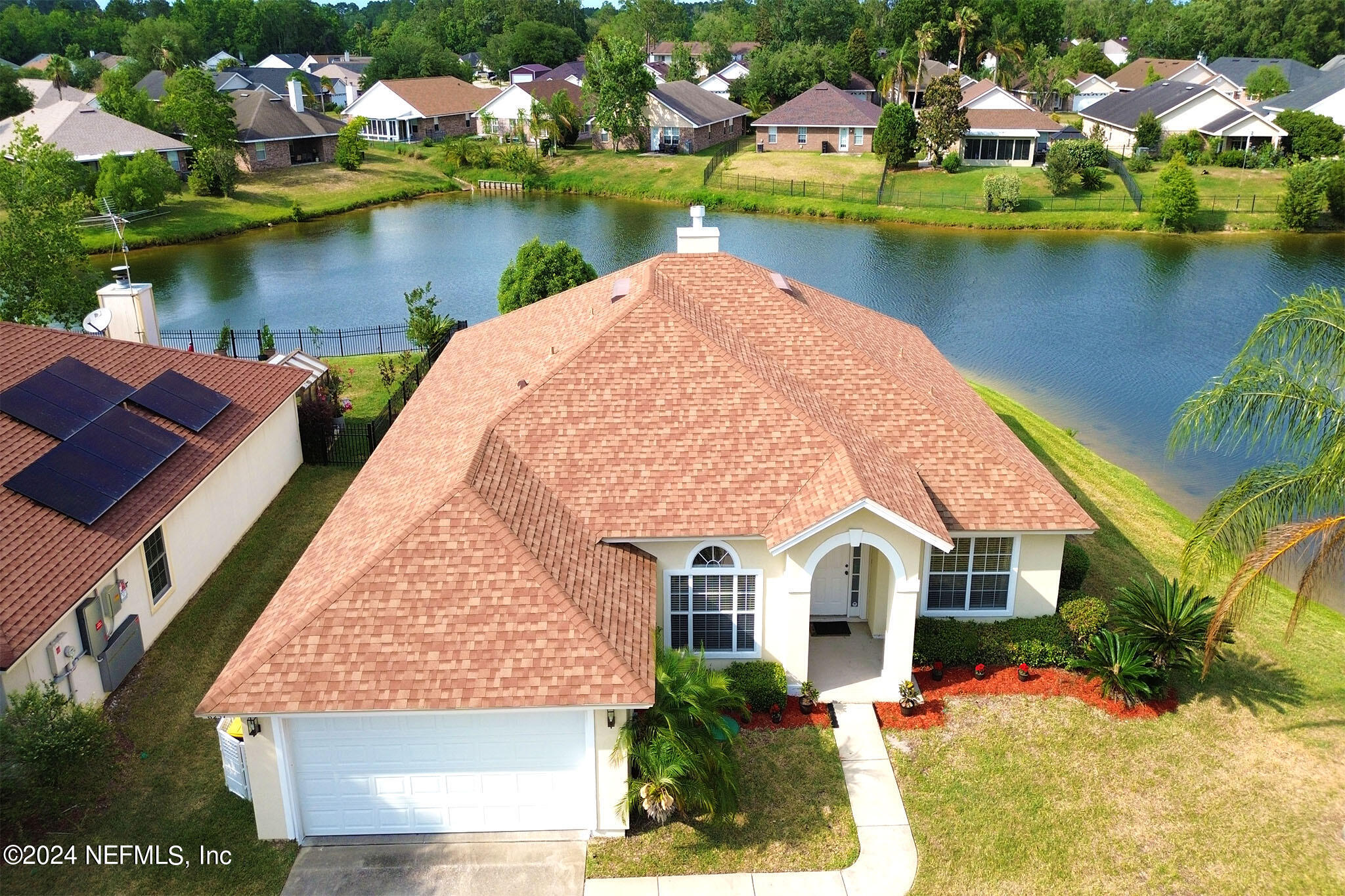 an aerial view of a house with a lake view