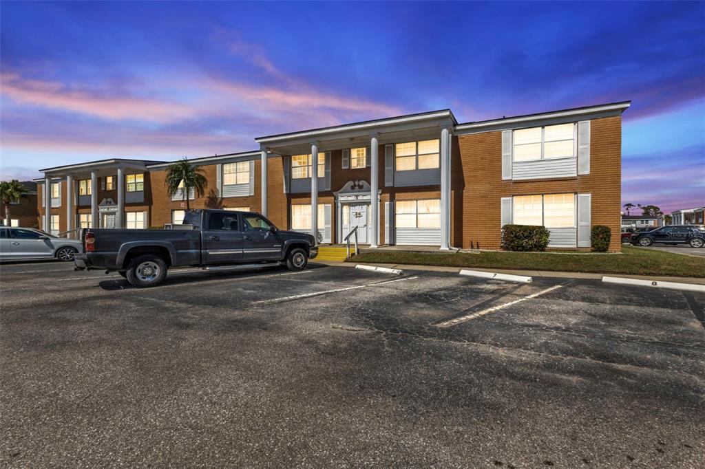 a front view of a house with a parking space