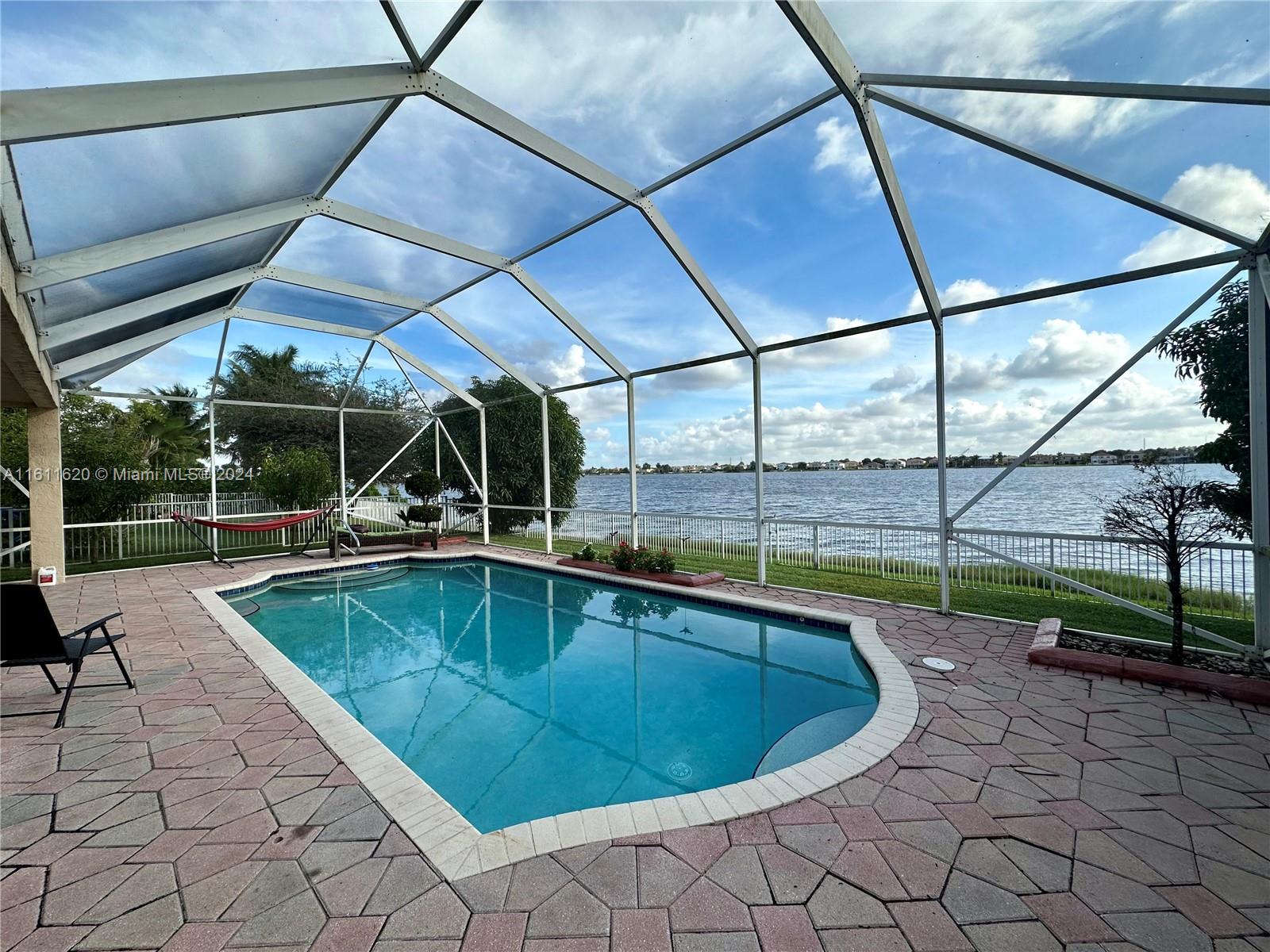 a view of a backyard with swimming pool