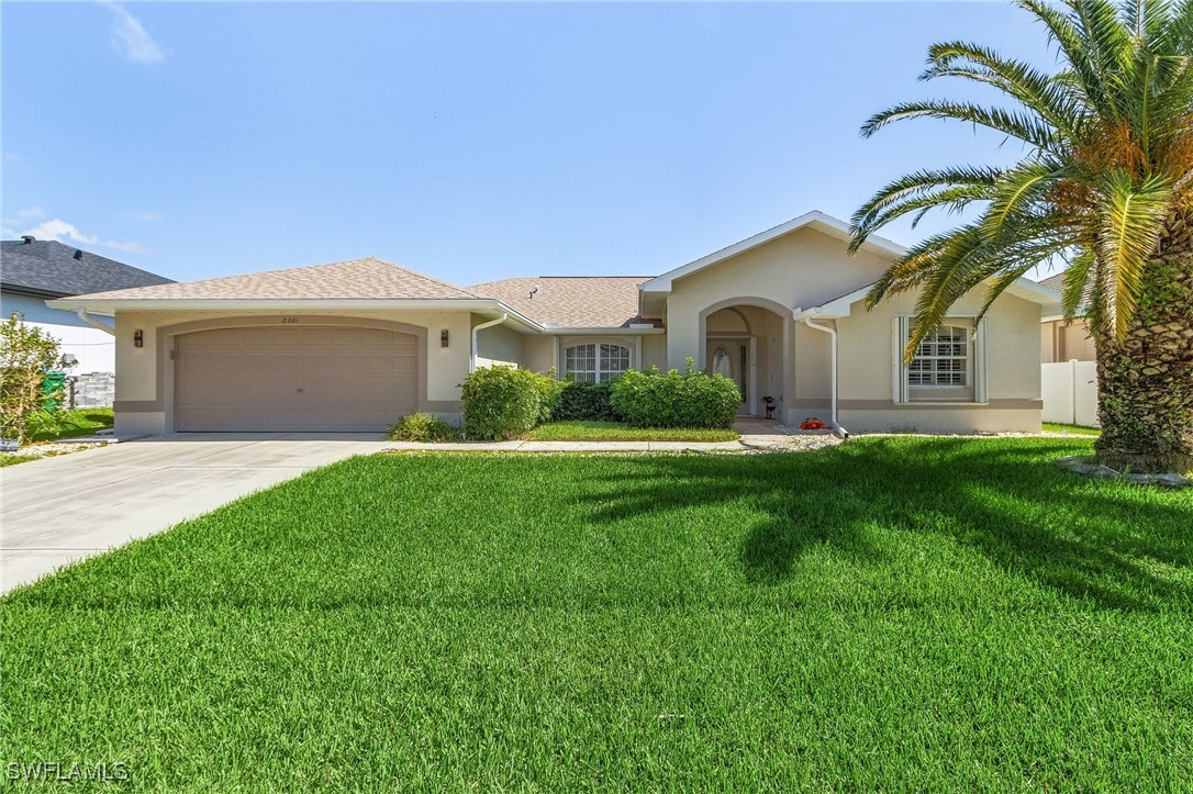 a front view of house with yard and green space