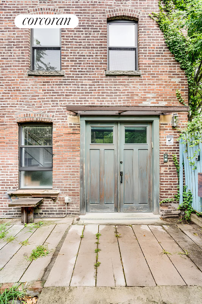 a brick house with a door and a table