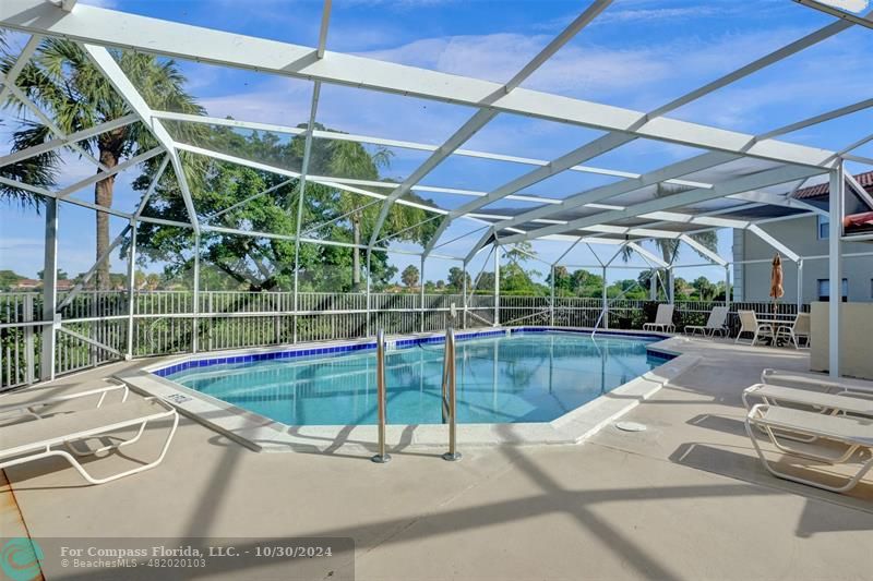 a view of a backyard with swimming pool