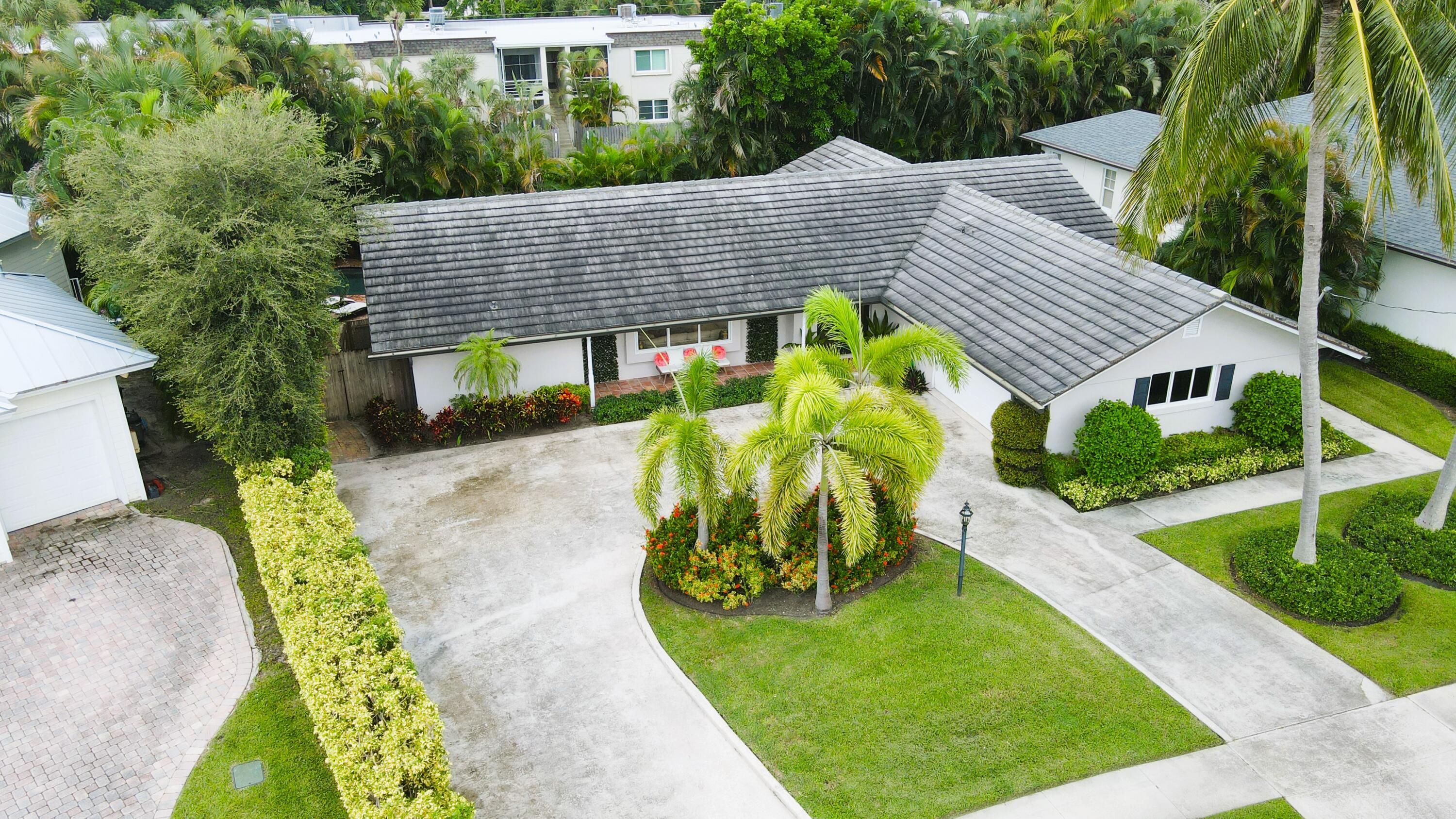 a view of a house with a yard and plants