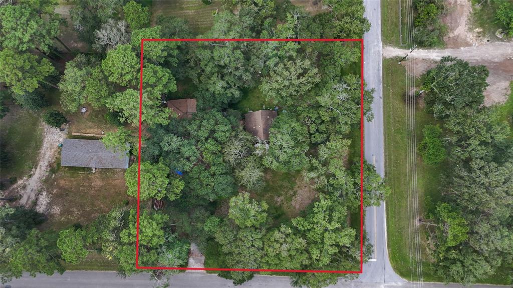 an aerial view of a house with a yard and garden