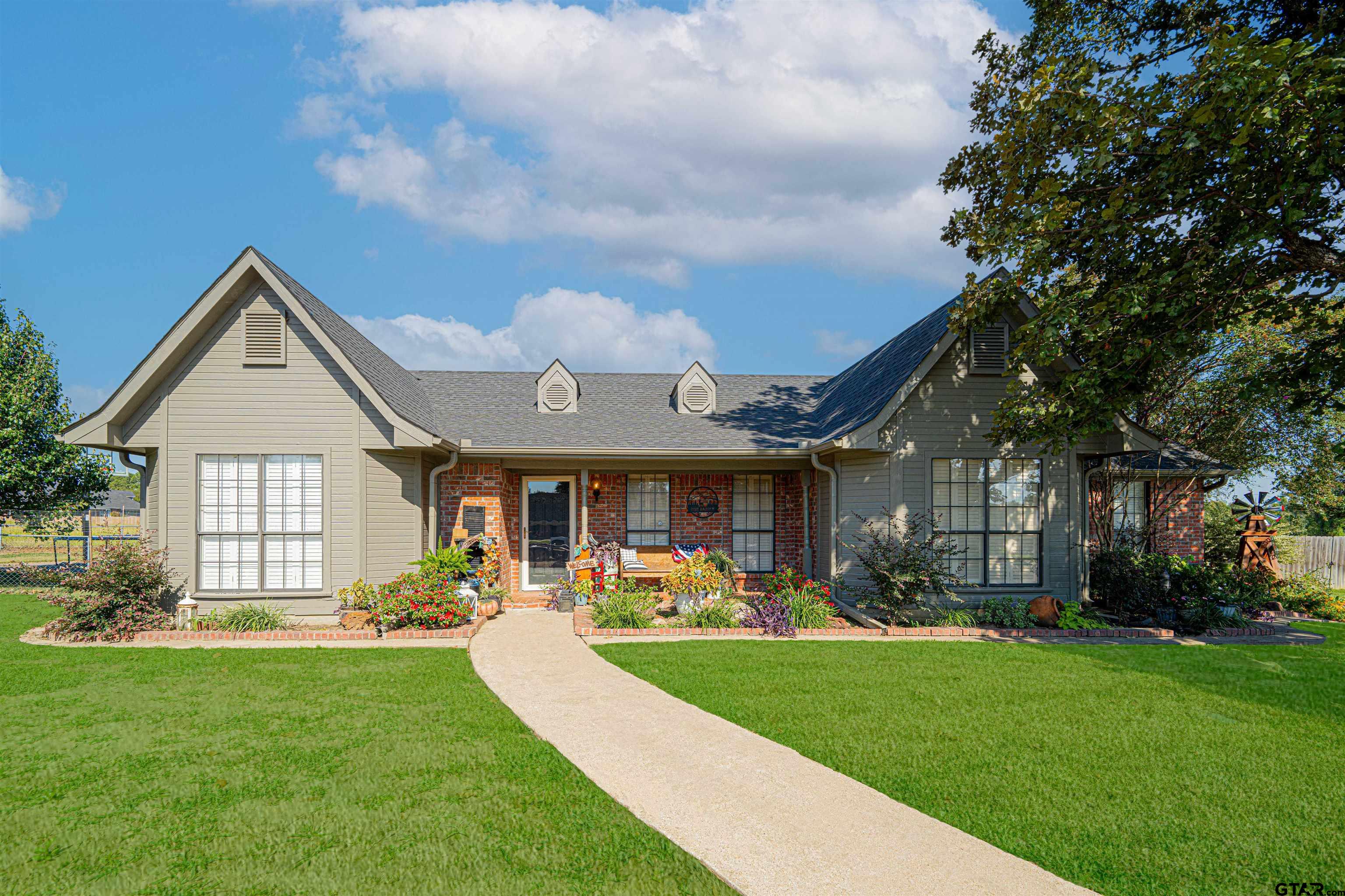 a front view of a house with garden