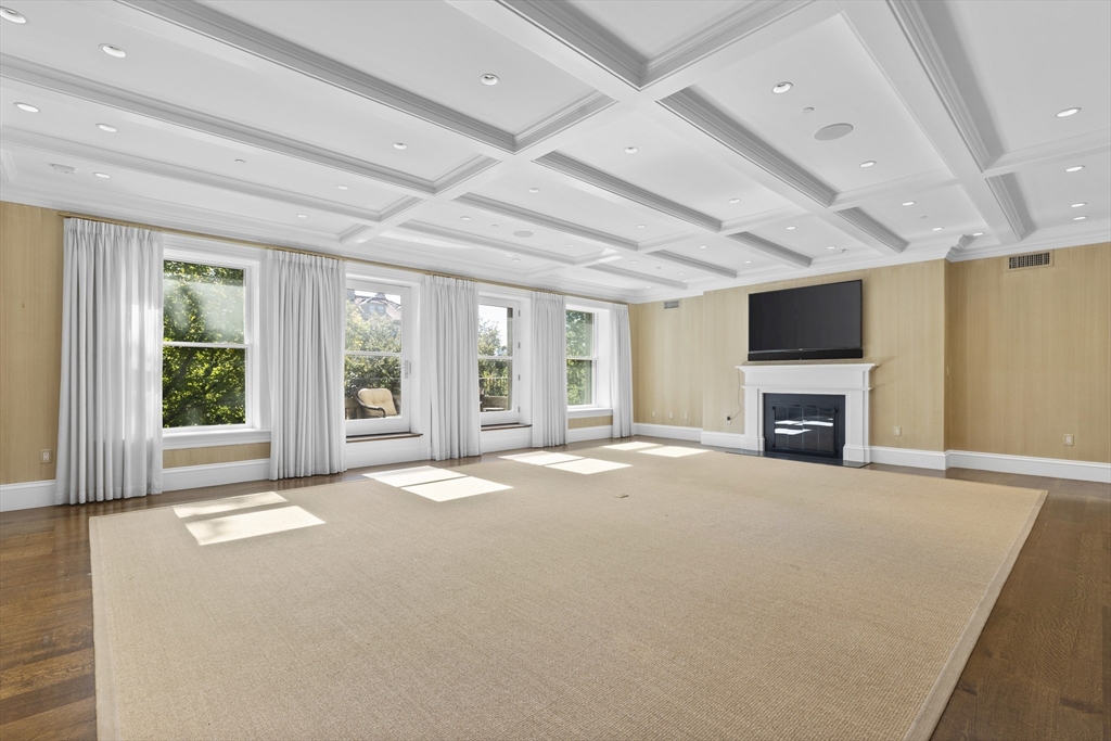 a view of an empty room with a fireplace and a window