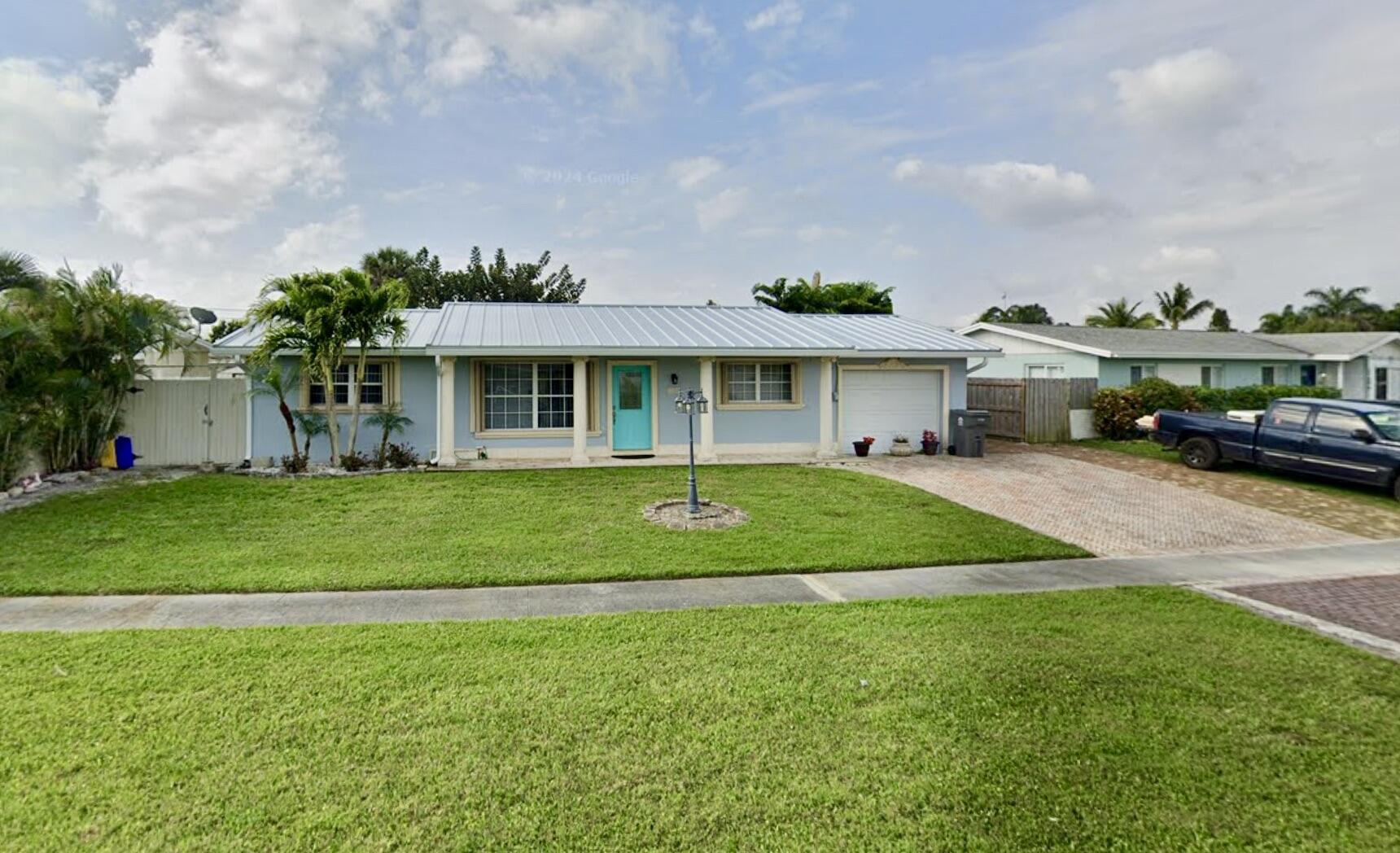 a front view of a house with a yard table and chairs