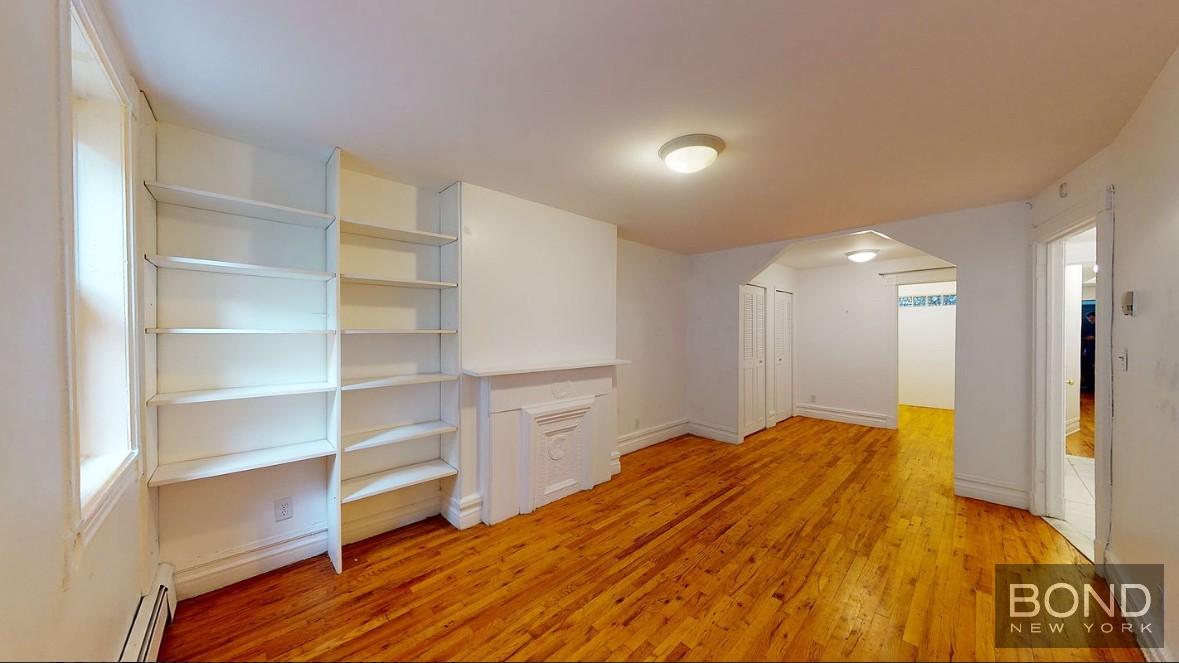 a view of a room with wooden floor and closet