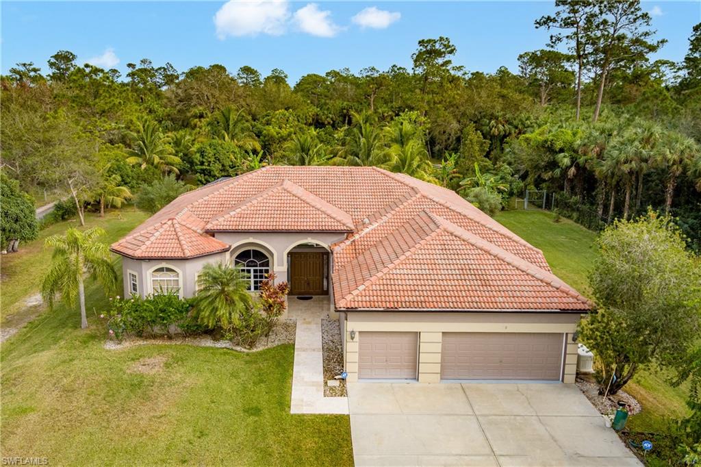 Mediterranean / spanish home with a front lawn and a garage