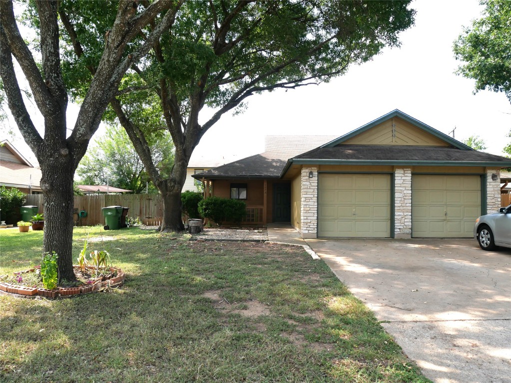 a front view of a house with a garden