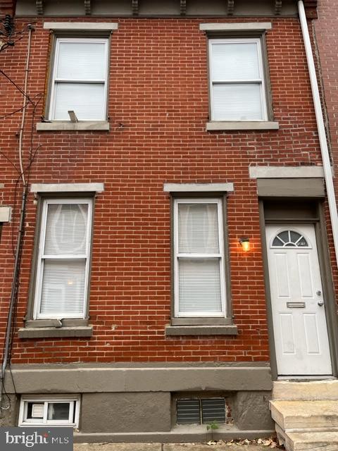 a red brick house that has window in it