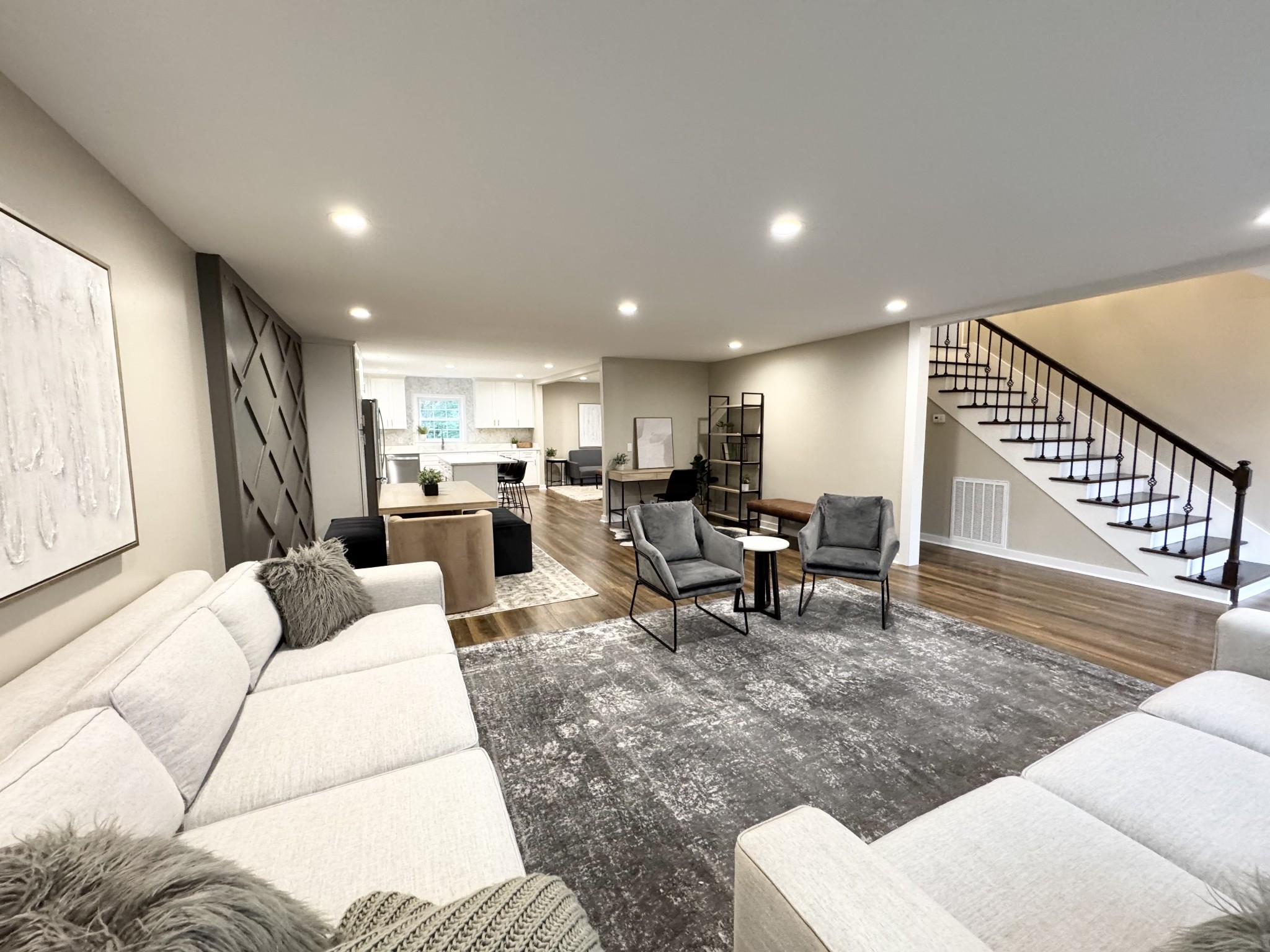 a living room with furniture and view of kitchen