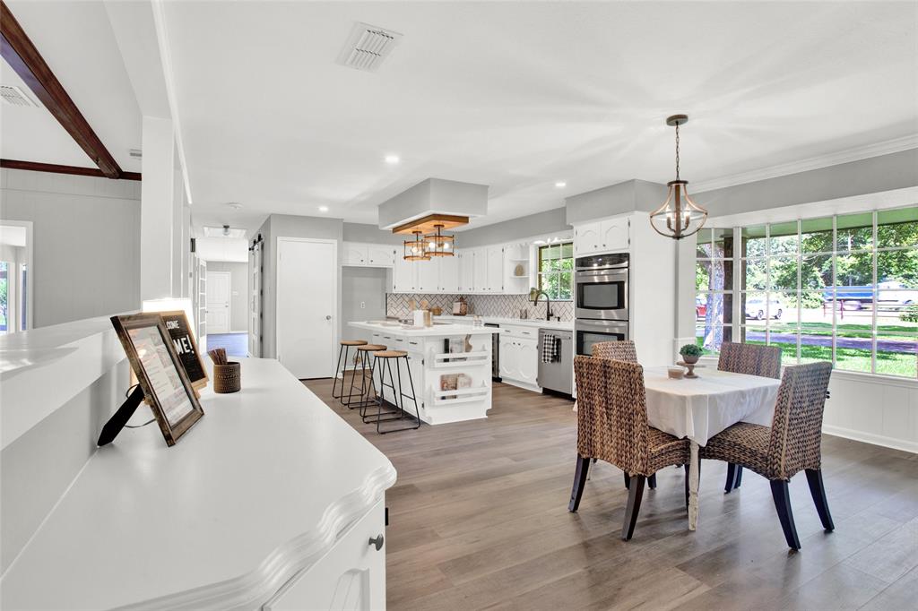 Beautiful bright kitchen with breakfast bar, built in buffet, and plenty room for 6-8 top table!