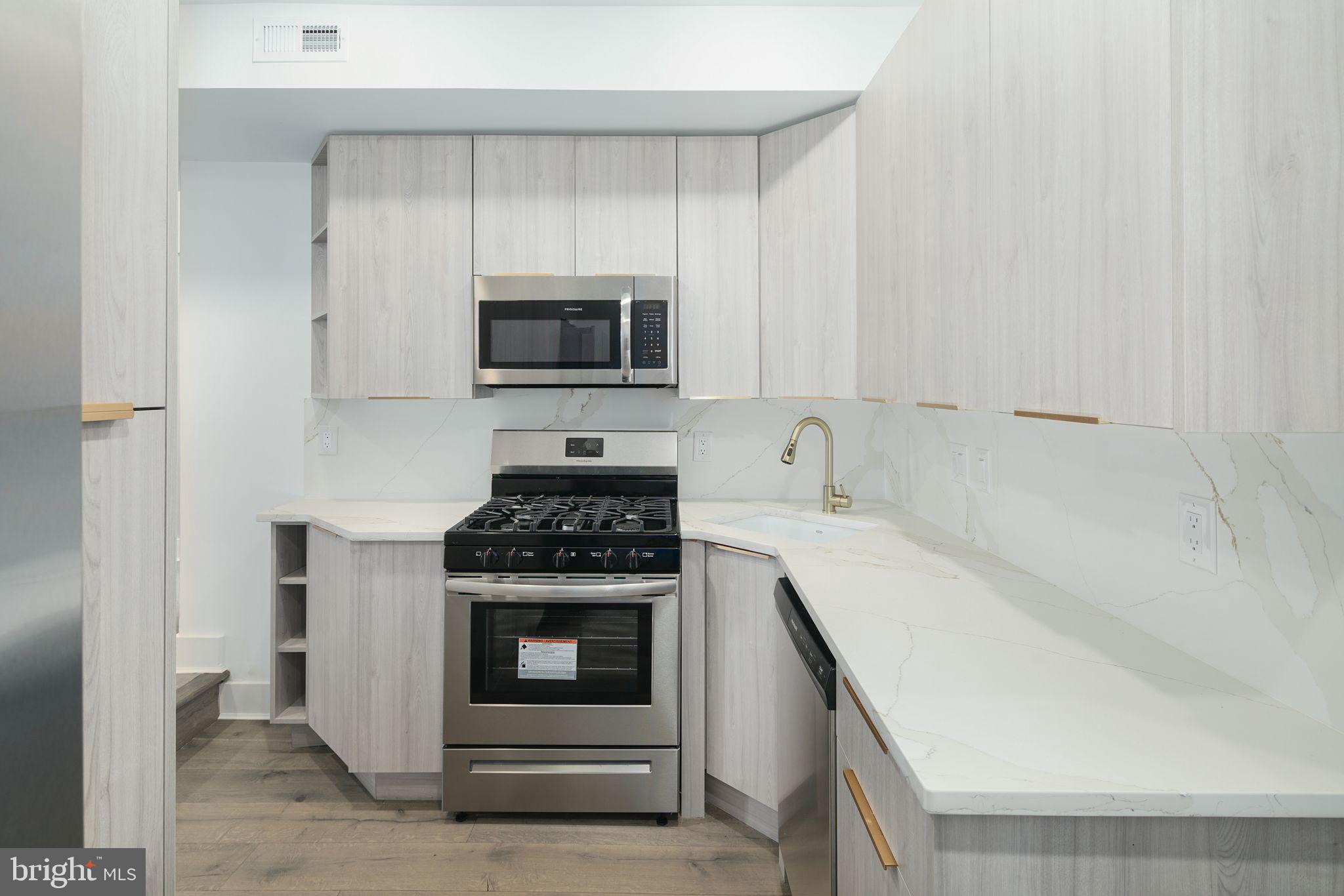 a kitchen with a stove and a microwave