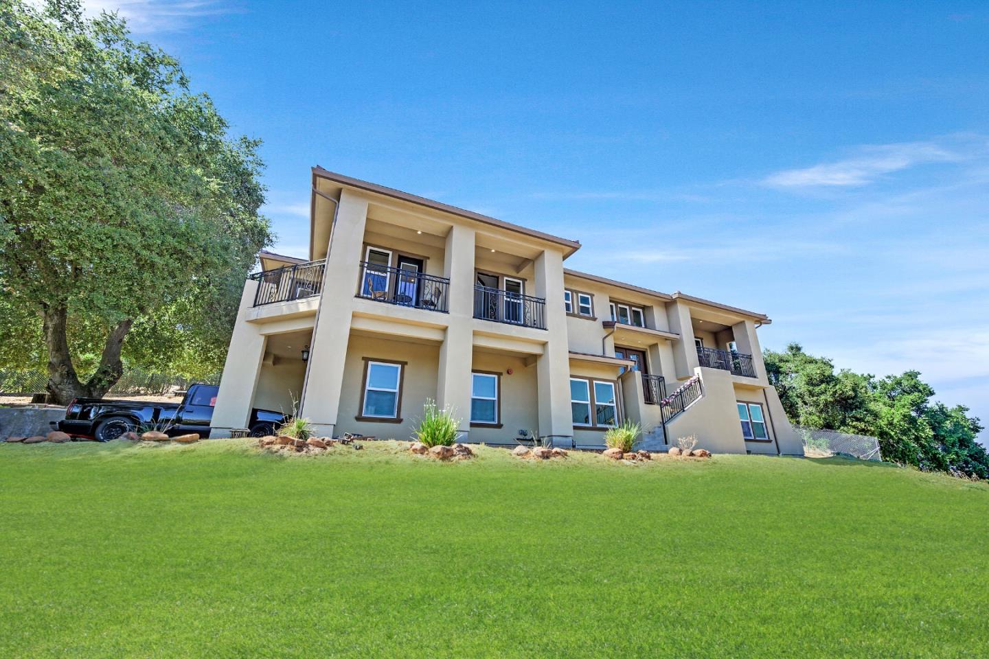 a front view of house with yard and green space