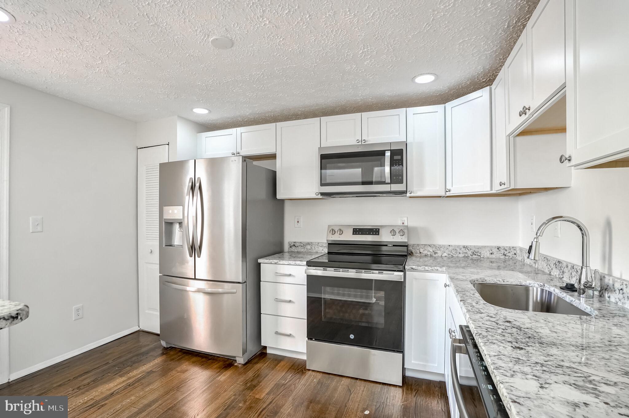 a kitchen with a sink stove and refrigerator