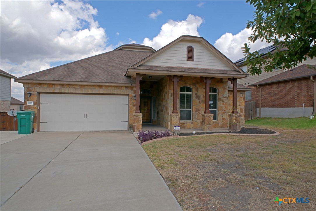 a front view of a house with a garden and plants