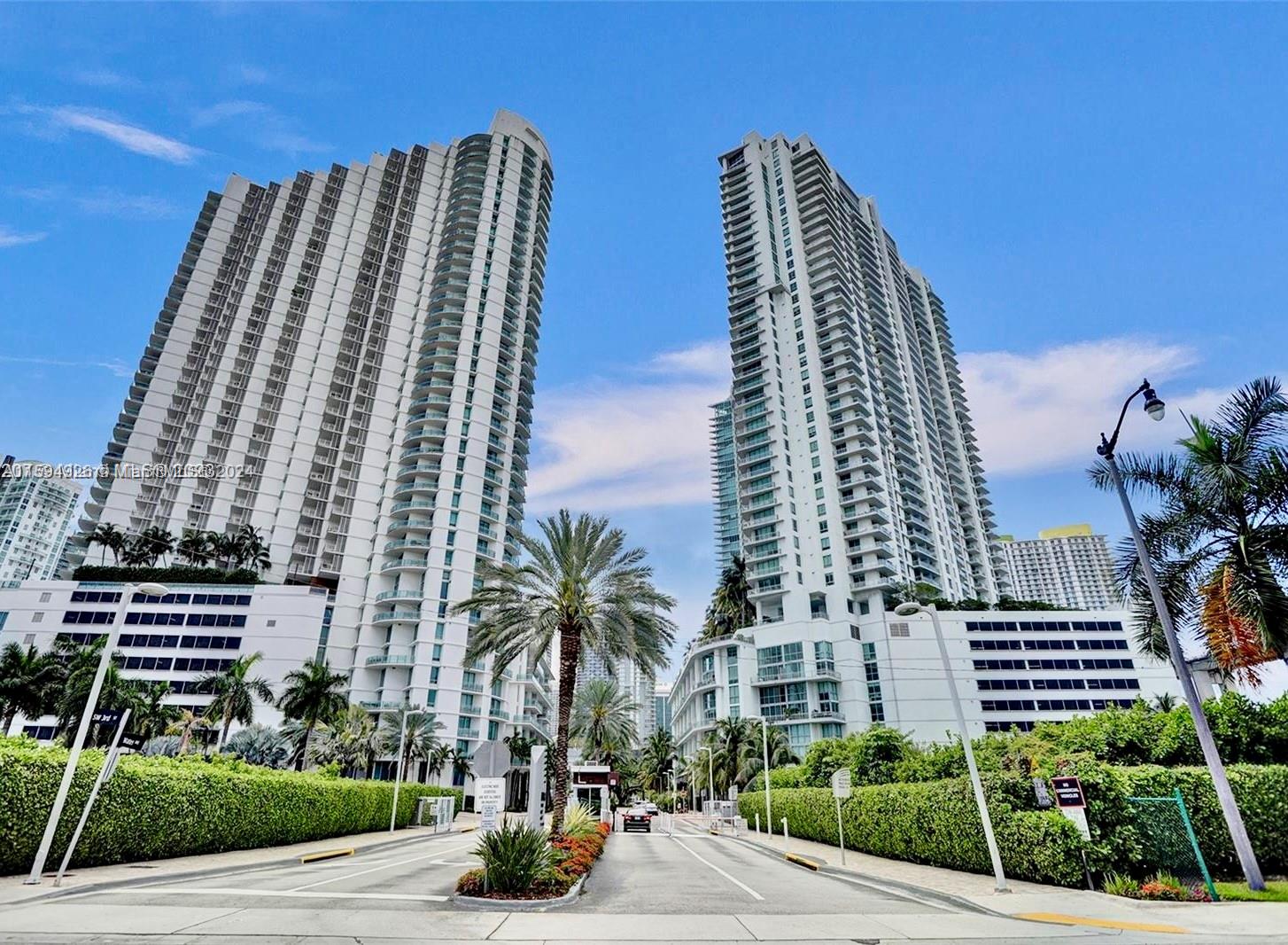 a view of a tall building next to a yard