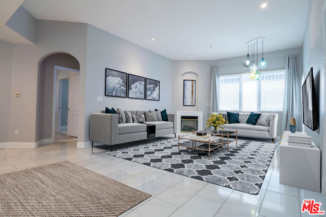 a living room with furniture rug and window