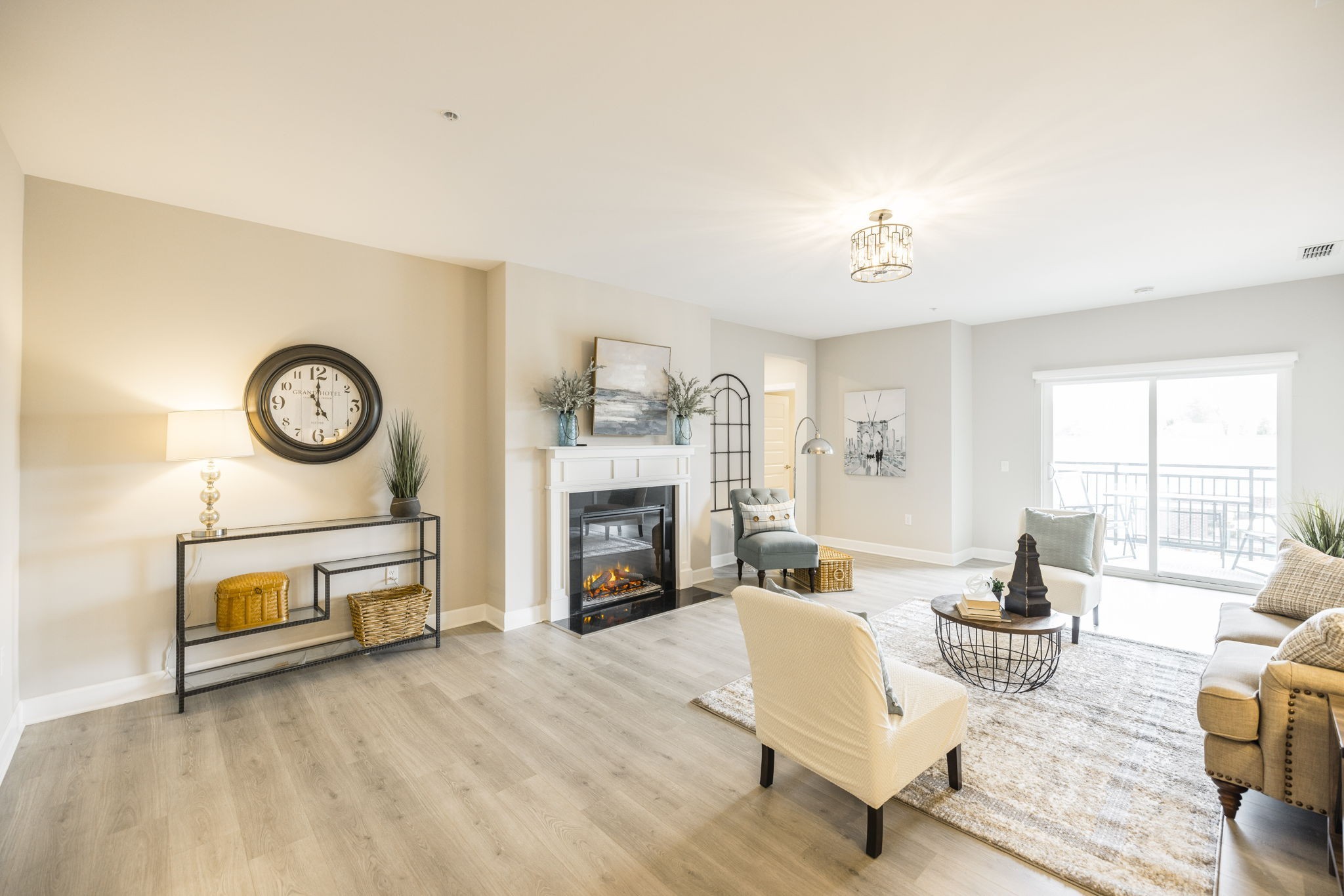 a living room with furniture a fireplace and a large window