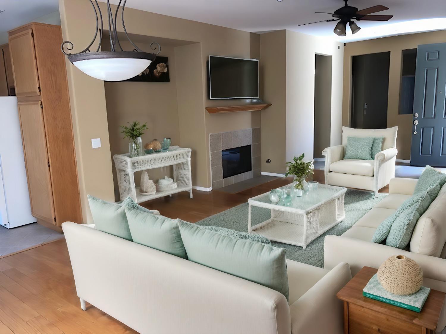 a living room with furniture a fireplace and a flat screen tv