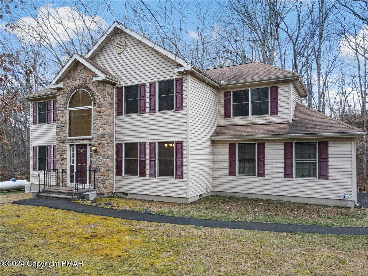 a front view of a house with a yard