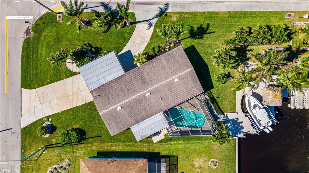 an aerial view of swimming pool with outdoor seating and yard